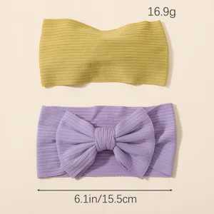 Set de diademas para bebé con cinta amarilla y lazo violeta de material de nailon.