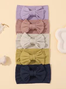 Conjunto de diademas lisas para bebe de nailon elastico con gran lazo decorativo.