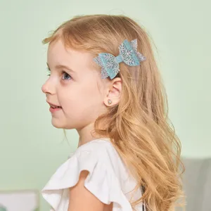Close-up of the cute blue glitter snowflake hair bow, wonderful holiday hair accessory for kids.