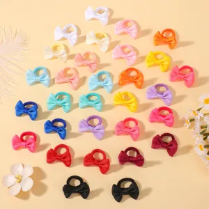 Kids mini bow hair ties detail shot, colorful ribbon hair ropes, soft elastic bands for baby.