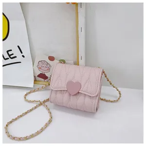 Detail of a pink mini crossbody bag for girls with heart-shaped closure and gold chain