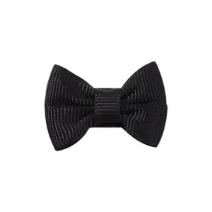 Detailed macro shot of a black grosgrain ribbon bow hair clip showing ribbed texture