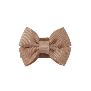 Detailed macro view of a brown grosgrain ribbon bow hair clip for toddlers and kids