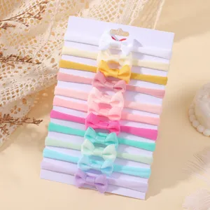 Detailed display of colorful elastic nylon baby bow headbands set on a display card