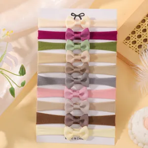 Detailed view of 10 colorful baby bow headbands made of soft elastic nylon material