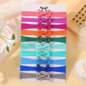 Set of 10 colorful elastic nylon baby headbands with grosgrain ribbon bows on display