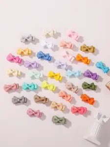 Collection of colorful mini grosgrain ribbon bow hair clips for kids and toddlers styling