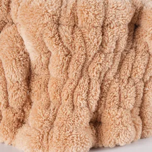 Close up view of soft coral fleece headband fabric detail showing plush fluffy texture clearly.