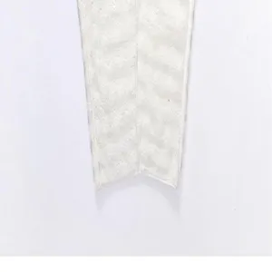Detail view of the soft white bubble fleece dry hair cap showing fine plush fabric texture.