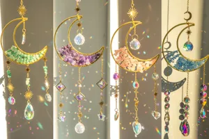 Dettaglio di quattro acchiappasole luna in cristallo con splendidi riflessi di luce arcobaleno.
