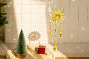 Close-up of crystal sunflower suncatcher reflecting rainbow light in sunlight.