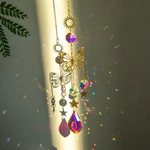 Close-up of golden butterfly suncatcher with teardrop crystal reflecting vibrant rainbows
