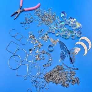 Assortment of silver butterfly and moon charms with crystal prisms for suncatchers.