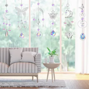 Set of six butterfly and moon crystal suncatchers hanging by a bright sunny window