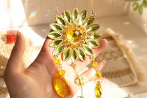 Detailed view of faceted crystal sunflower suncatcher creating rainbow light reflections