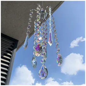 Close-up of crystal suncatcher with rainbow prisms hanging against a bright blue sky.