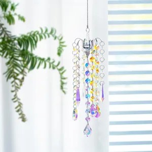 Decorative crystal suncatcher prism hanging ornament reflecting rainbow light in window