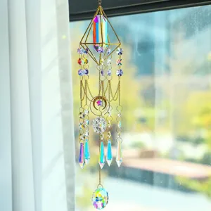 Close-up of a decorative crystal suncatcher with golden metal frame and star charms