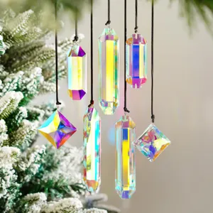 Macro view of seven iridescent crystal suncatcher prisms hanging on a snowy Christmas tree