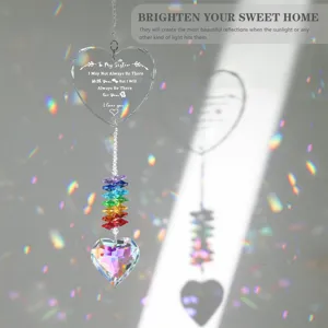 Detail of crystal suncatcher showing heart engraving and rainbow light reflections.
