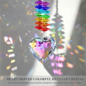 Heart-shaped K9 clear crystal suncatcher creating colorful rainbow light reflections.