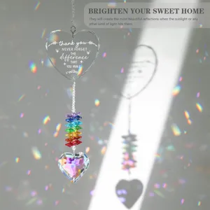 Heart-shaped crystal suncatcher with rainbow beads creating colorful reflections