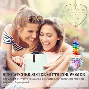 Lifestyle detail of heart crystal suncatcher gift shown with happy sisters outdoors