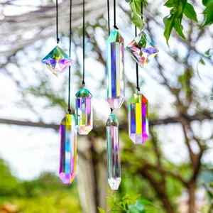 Close-up of seven iridescent crystal prisms creating vibrant rainbow reflections in a garden.