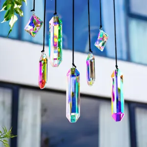 Close-up of hanging iridescent crystal sun catchers against a blurred garden backdrop