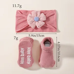 Detailed view of pink baby floral headband and anti-slip socks set with product dimensions