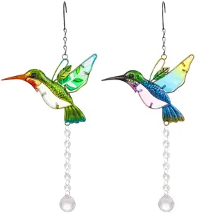 Close-up of colorful hummingbird suncatchers with faceted crystal ball pendants