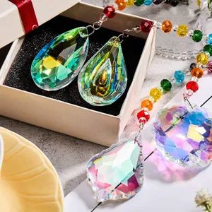 Detailed view of crystal suncatcher pendants with vibrant rainbow prism reflections.