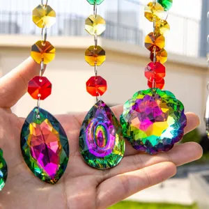 Macro view of multi-faceted rainbow crystal suncatchers held in hand for garden decor