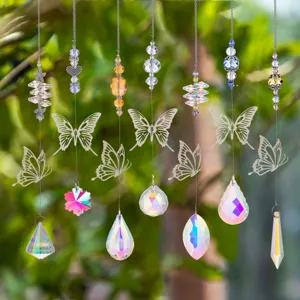 Close-up of crystal butterfly suncatchers creating vibrant rainbow prisms in a garden.