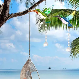 Decorative hummingbird crystal suncatchers hanging in a tropical garden setting