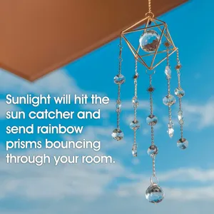 Detailed view of a geometric gold crystal suncatcher hanging against a blue sky.