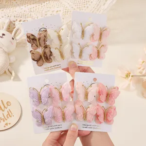 Vista macro detallada de cuatro juegos de pinzas para el cabello de mariposa bordada de color