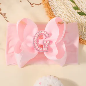 Bandeau bébé rose avec nœud papillon et décoration lettre G en perles et strass