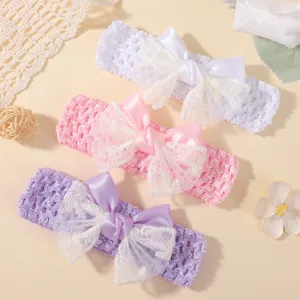 Detailed macro view of lace and satin bows on three pastel-colored crochet baby headbands