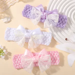 Close-up detail of three breathable baby headbands with delicate lace butterfly bows