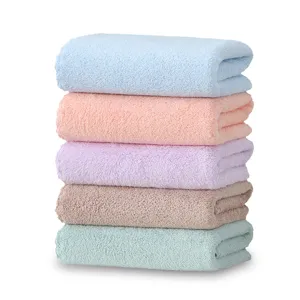 Soft coral fleece face towel stack in multi pastel colors for daily bathroom use.