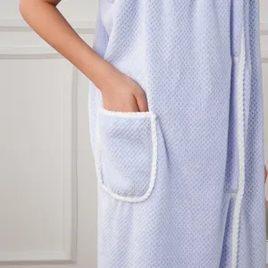Wearable bath towel robe detail, soft absorbent fleece fabric, convenient pocket design.