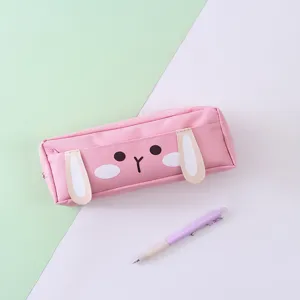 Close-up detail of the cute pink canvas pencil pouch featuring 3D bunny ears and sweet face.