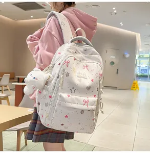 Cute student backpack detail, large capacity white school bag with stars, bows, and bunny pendant.