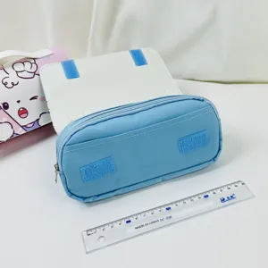 Close up detail of the blue double-layer canvas pencil case with zipper and Velcro strap design.