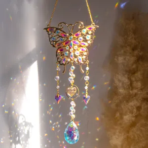 Detailed view of gold butterfly suncatcher with crystal prisms and heart charm