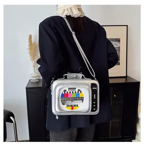 Detailed macro shot of a silver retro TV-shaped crossbody bag featuring unique heart accents.