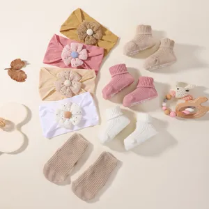 Detailed display of colorful soft floral baby headbands and non-slip sock accessory sets