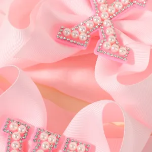 Accessoire de cheveux doux avec nœud en gros-grain rose, perles et strass