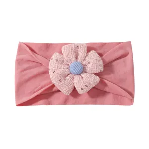 Cute pink wide baby headband featuring a decorative tweed flower with blue button